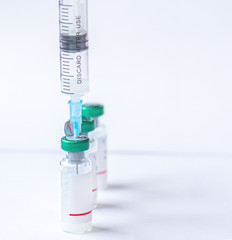 Syringe with a vaccine Coronavirus, COVID-19, nCoV 2019 and flu vaccine on white background....
