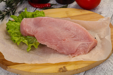 Raw Turkey steak served rosemary