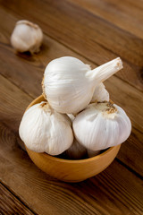 Isolated garlic whole on wooden background. Cooking ingredient.