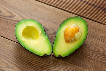 Avocado on wooden table, isolated. Healthy food.