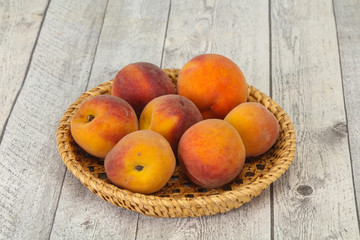 Peach heap in the wooden basket