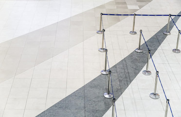 Empty airport check-in counter barricade rope with no body in the queue