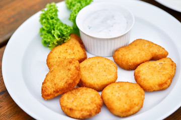 A plate of chicken nuggets on a table