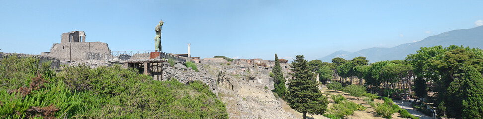 Fototapeta premium Panoramic view of Ruins of Pompeii city destroyed in 79 B.C. by the eruption of Vesuvius Volcano , Italy. Blue sky