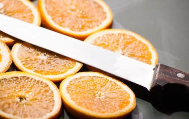 Fototapeta na wymiar sliced orange chunks with knife