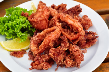 A plate full of fried squid in batter