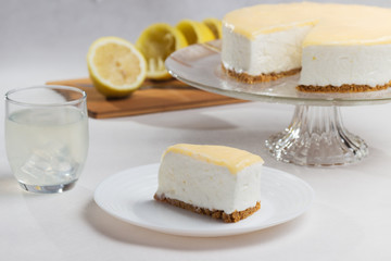 Cold lemon cake with cookies, lactose free, glass with lemonade.