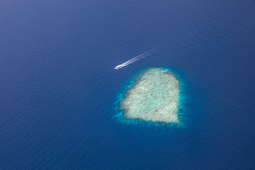 Tropical islands and atolls in Maldives from aerial view. Maldives consist of many islands and...