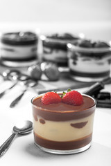 Chocolate dessert with layered mascarpone, decorated with strawberries.