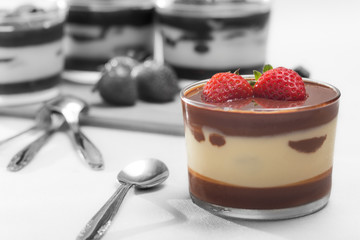 Chocolate dessert with layered mascarpone, decorated with strawberries.