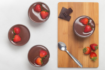 Fototapeta na wymiar Chocolate dessert with layered mascarpone, decorated with strawberries.
