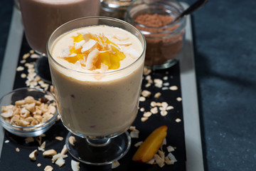 milkshakes with chocolate, oatmeal and mango in glasses, closeup