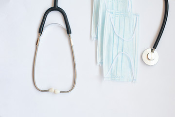 stethoscope and blue medical mask on a white background