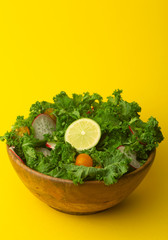 Fresh green salad in a wooden bowl. Healthy, diet, vitamins, vegetarian,  proper food and lifestyle concept.