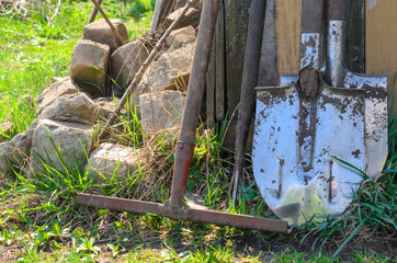 dirty gardening tools. shovel and a rake