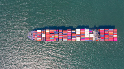 Container , container ship in export and import business and logistics. Shipping cargo to harbor by...