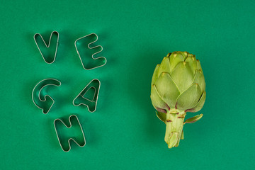 green artichokes on color background