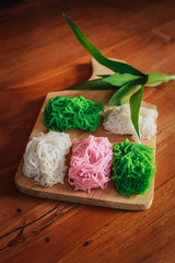Food Photography Petulo (Putu Mayan g) is Traditional Javanese food of rice flour strands curled up into a ball; eaten with coconut milk and palm sugar.