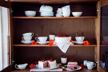 Cakes with red currant decorated with fresh red berries and flowers