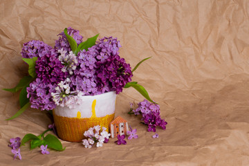 Blooming lilac branches in a clay pot, closeup