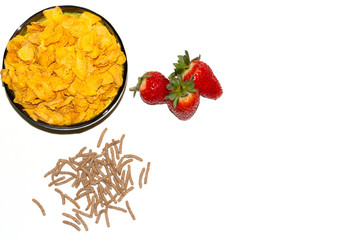 tasty cornflackes, strawberries and bran on a white background