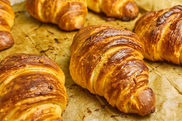 Puff pastry croissants with chocolate on baking sheet. Homemade cooking. Concept of international cuisine. 