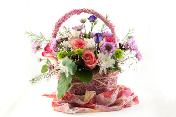roses and other flowers in a beautiful basket