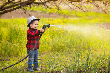 kid boy watering garden