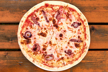 A marinara pizza sitting on top of a wooden table