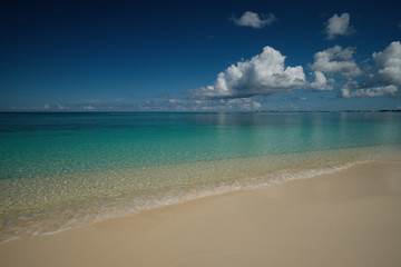 Crystal clear waters and pinkish sands on empty seven mile beach on tropical carribean Grand Cayman Island
