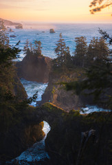 Sunset on the coast of oregon standing on top of a rock arch above the waves © Matt