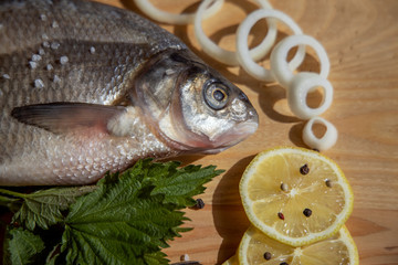 Head of bream fish in close-up lies on wooden Board, fish is ready for frying.