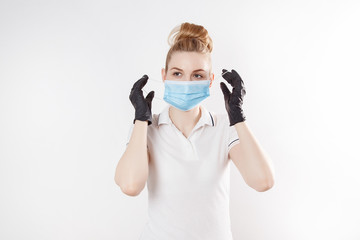 Girl in a medical mask and rubber gloves. Means of protection in quarantine.