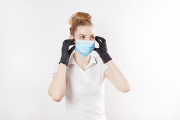 Girl in a medical mask and rubber gloves. Means of protection in quarantine.