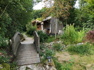 Garden with wooden bridge and wooden house