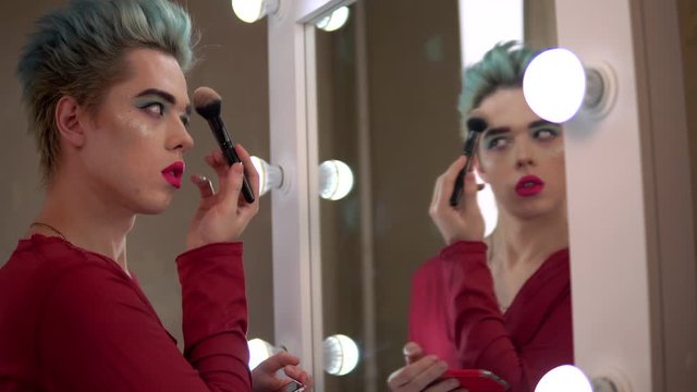 homosexual man put make up in mirror transvestite, travesti diva show