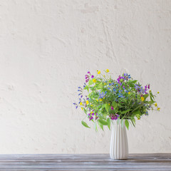 summer wild flowers in vase on white background