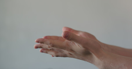 pov shot of man showing clean hands after applying sanitizer gel to his hands closeup