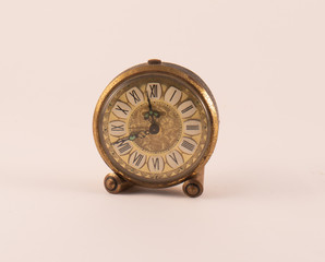 Small old clock on a white background