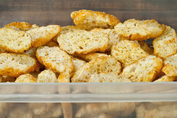 Yellow crackers close up. Texture of breadcrumbs. Many pieces of white dry bread.