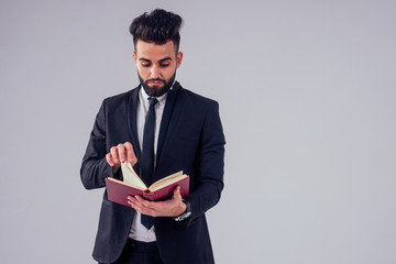 young handsome black hair man in stylish business suit in studio isolate white background