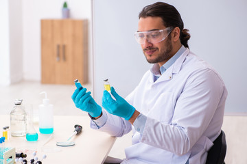 Young male chemist working in the lab