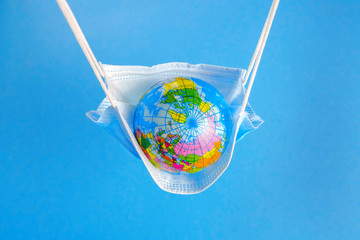 Earth globe in medicine mask to fight against Corona virus - 347580467