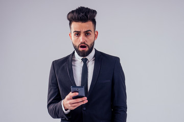 young handsome black hair man in stylish business suit in studio isolate white background