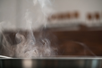 steam rising from fry pan while cooking food closeup