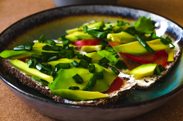 sandwich with avocado and a cup of coffee. delicious breakfast