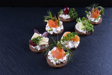 sandwiches of salmon, shrimp, dill and sauce on the table