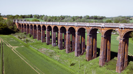 Landscape of old rustic train bridge in the  British countryside