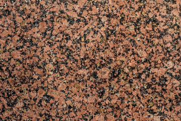 close up of a polished red marbled granite texture.