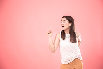 Portrait of a young woman on an isolated pink background.